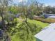 Expansive backyard featuring a large tree providing ample shade and a well-maintained lawn, bordered by wooden fences at 8303 Croton Ave, Tampa, FL 33619