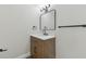 Modern bathroom with wood vanity, marble countertop, and sleek fixtures at 8303 Croton Ave, Tampa, FL 33619