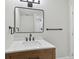 Modern bathroom featuring wood vanity, marble countertop, black hardware, and a shower at 8303 Croton Ave, Tampa, FL 33619