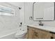 Updated bathroom with marble-style tiles and a vanity featuring matte black hardware at 8303 Croton Ave, Tampa, FL 33619