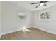 Spacious bedroom with luxury vinyl plank flooring and two bright, sunny windows at 8303 Croton Ave, Tampa, FL 33619