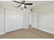 This bedroom features a ceiling fan, light colored walls, and luxury vinyl plank flooring at 8303 Croton Ave, Tampa, FL 33619