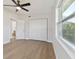 Bedroom with LVP flooring, modern ceiling fan, closet, and ensuite bath access at 8303 Croton Ave, Tampa, FL 33619