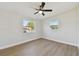 Bright bedroom featuring LVP flooring and two windows offering great natural light at 8303 Croton Ave, Tampa, FL 33619