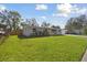 Charming home featuring a well-kept lawn, fresh landscaping, and a vibrant yellow door at 8303 Croton Ave, Tampa, FL 33619