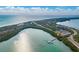 Gorgeous aerial view of land showing waterway, a pier with boats docked, and beach access at 860 Virginia St # 303, Dunedin, FL 34698