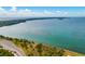 Breathtaking aerial view showcasing the coastline with lush trees, and clear blue waters at 860 Virginia St # 303, Dunedin, FL 34698