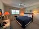 Bedroom with a ceiling fan, soft lighting and comfortable bed at 860 Virginia St # 303, Dunedin, FL 34698