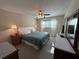 Serene bedroom with a comfortable bed, ceiling fan, and ample natural light at 860 Virginia St # 303, Dunedin, FL 34698