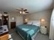 Cozy bedroom featuring a ceiling fan, closet, neutral walls, and natural light at 860 Virginia St # 303, Dunedin, FL 34698