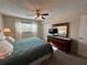 Bedroom with a full mirror, closet, and sun-filled window overlooking the home's surroundings at 860 Virginia St # 303, Dunedin, FL 34698