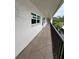 Outdoor hallway with decorative floors and views to the exterior of the property at 860 Virginia St # 303, Dunedin, FL 34698