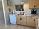 Kitchen featuring wood cabinets, stainless steel sink, and modern appliances at 860 Virginia St # 303, Dunedin, FL 34698