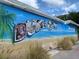 Colorful wall mural depicting the city of Dunedin with beach background at 860 Virginia St # 303, Dunedin, FL 34698