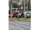 Well maintained parking lot with trees surrounding building at 860 Virginia St # 303, Dunedin, FL 34698