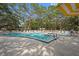 Community pool featuring a hot tub and lounge chairs for tenants and guests at 860 Virginia St # 303, Dunedin, FL 34698