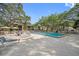 Beautiful community pool featuring lounge chairs and mature landscaping at 860 Virginia St # 303, Dunedin, FL 34698