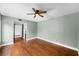 Bedroom featuring hardwood floors, ceiling fan, and a doorway to another room at 8730 143Rd N St, Seminole, FL 33776