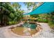 Backyard pool featuring landscaping, surrounding hardscape, and shade sails overhead at 8730 143Rd N St, Seminole, FL 33776