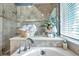 Relaxing bathroom with soaking tub, shower, and window at 905 Linn Harbor Ct, Tarpon Springs, FL 34689