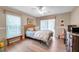 Bedroom with a queen bed, ceiling fan, and wood dresser at 905 Linn Harbor Ct, Tarpon Springs, FL 34689