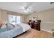 Bedroom with a queen bed, ceiling fan, and wood dresser at 905 Linn Harbor Ct, Tarpon Springs, FL 34689