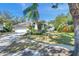 House exterior showcasing a large driveway and lush landscaping at 905 Linn Harbor Ct, Tarpon Springs, FL 34689