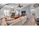 Bright living room with a cozy fireplace and views into the kitchen and dining area at 905 Linn Harbor Ct, Tarpon Springs, FL 34689