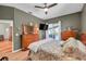 Comfortable main bedroom with wood flooring, and ensuite bath access at 905 Linn Harbor Ct, Tarpon Springs, FL 34689