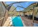 Inviting pool with a screened enclosure and patio furniture at 905 Linn Harbor Ct, Tarpon Springs, FL 34689