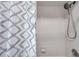 Clean shower with gray and white patterned curtain at 905 Linn Harbor Ct, Tarpon Springs, FL 34689