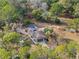 Aerial view showcases the house with a pool, deck, and surrounding trees, providing privacy and shade at 9445 Preston Rd, Brooksville, FL 34601