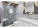 Bathroom featuring modern shower stall with black tile floor, and white vanity at 9445 Preston Rd, Brooksville, FL 34601