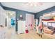 Bedroom featuring wallpaper, pink ceiling fan and closet, and tiled floor at 9445 Preston Rd, Brooksville, FL 34601