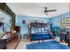 Blue bedroom featuring a bunk bed and a large wood dresser with mirror at 9445 Preston Rd, Brooksville, FL 34601