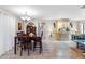 Spacious dining area featuring a classic wood table with seating for six, and tile flooring throughout at 9445 Preston Rd, Brooksville, FL 34601