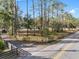 Gated driveway of the property surrounded by lush trees and landscaping at 9445 Preston Rd, Brooksville, FL 34601