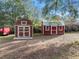 View of two well-maintained outbuildings offering versatile storage solutions on a sunny day at 9445 Preston Rd, Brooksville, FL 34601