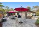 Outdoor patio features furniture, umbrellas, and a grill, ideal for entertaining and enjoying outdoor meals at 9445 Preston Rd, Brooksville, FL 34601