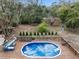 Outdoor in-ground pool with a wooden deck and lounge seating, perfect for relaxation and entertainment at 9445 Preston Rd, Brooksville, FL 34601