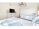 Guest bedroom with twin beds, dresser, and coastal decor at 9495 Blind Pass Rd # 605, St Pete Beach, FL 33706