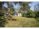 Large backyard with mature trees and a shed at 9810 Parsons St, Tampa, FL 33615