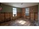 Bedroom under renovation, showing exposed framing and flooring at 9810 Parsons St, Tampa, FL 33615