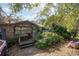 Rustic wood-sided home with a covered porch and mature landscaping at 9810 Parsons St, Tampa, FL 33615