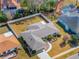 An aerial view of a well-maintained single-story home with a fenced backyard and a long driveway at 10340 Ventura Dr, Spring Hill, FL 34608