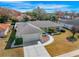 Lovely single-story home with lush landscaping, a wide driveway, and mature trees creating a private oasis at 10340 Ventura Dr, Spring Hill, FL 34608