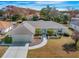Charming single-Gathering home with a well-maintained lawn, complemented by lush landscaping and mature trees at 10340 Ventura Dr, Spring Hill, FL 34608