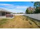 Wide view of a spacious, fenced backyard with a hot tub at 10340 Ventura Dr, Spring Hill, FL 34608