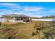 Wide view of a fenced backyard featuring a hot tub, and screened in patio at 10340 Ventura Dr, Spring Hill, FL 34608