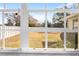 Backyard view through a large window with a grassy yard and white privacy fence at 10340 Ventura Dr, Spring Hill, FL 34608